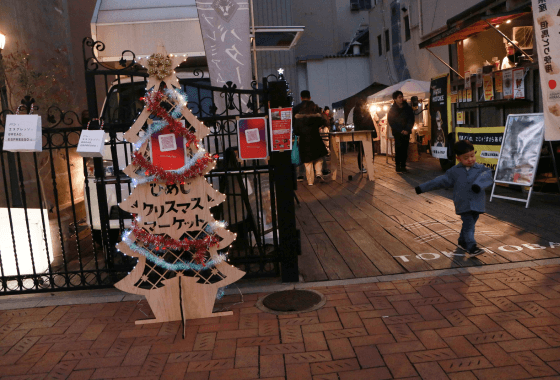 夜のクリスマスマーケットの入り口と飾られた看板